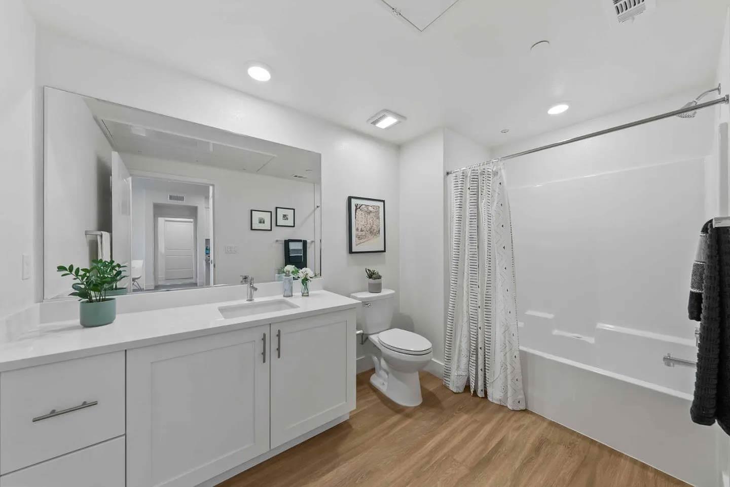 5925 Charlotte Drive, Unit 414 San Jose, CA 95123 - Photo 8 of 18 a bathroom with a double vanity sink toilet mirror and bathtub