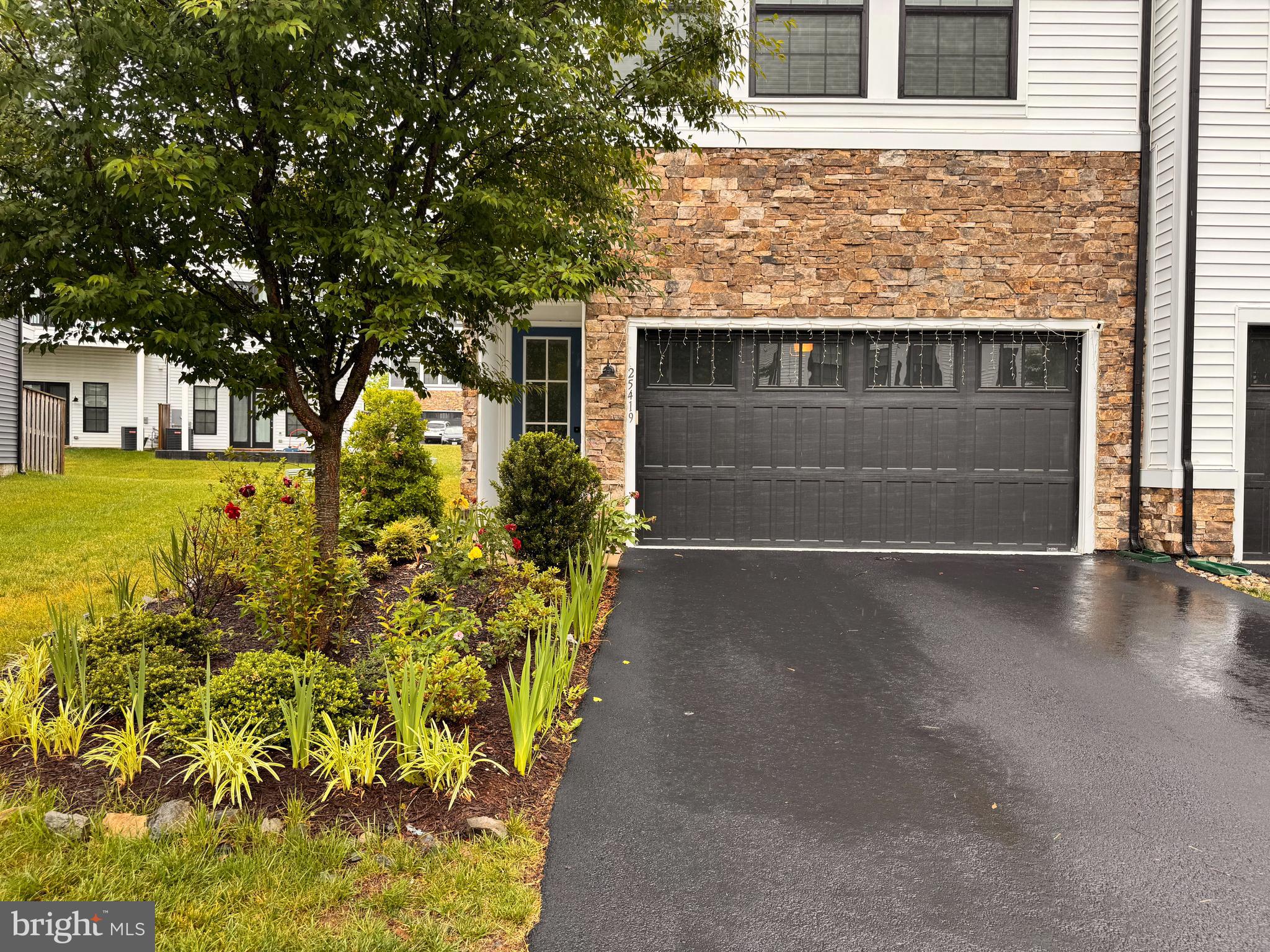 25419 Reed Orchard Terrace Chantilly, VA 20152 - Photo 2 of 47 a front view of a house with a yard