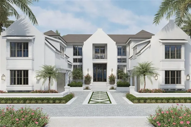 a front view of white house with a yard