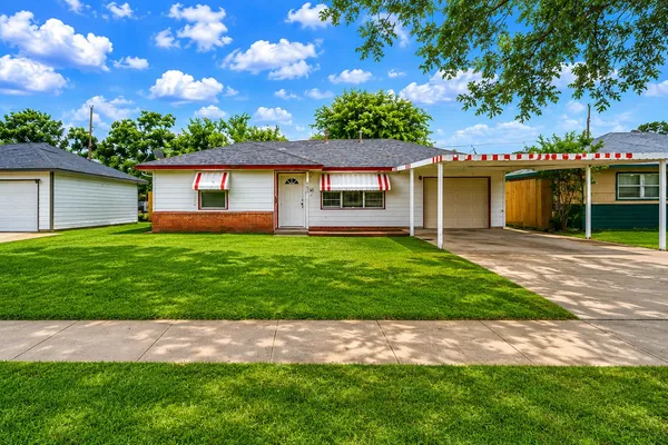 a front view of house with yard and green space
