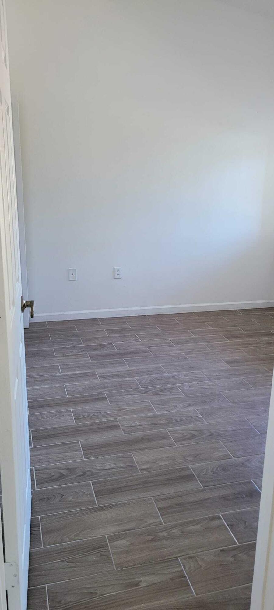 3478 Briar Bay Boulevard, Unit 202 West Palm Beach, FL 33411 - Photo 11 of 23 a view of room with wooden floor
