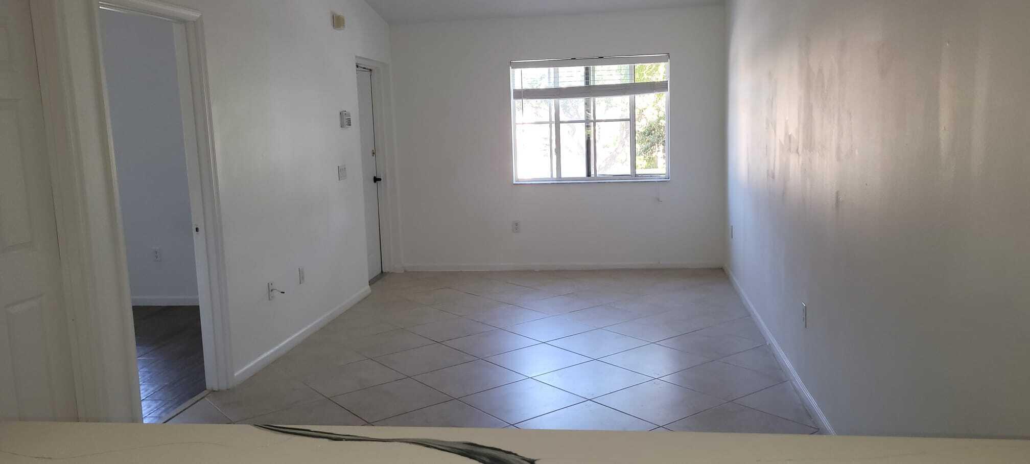 3478 Briar Bay Boulevard, Unit 202 West Palm Beach, FL 33411 - Photo 15 of 23 an empty room with windows