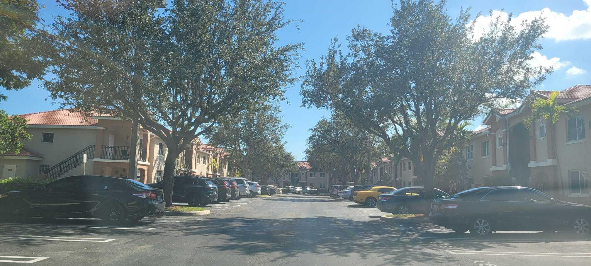 3478 Briar Bay Boulevard, Unit 202 West Palm Beach, FL 33411 - Photo 20 of 23 a view of a fire pit with large trees
