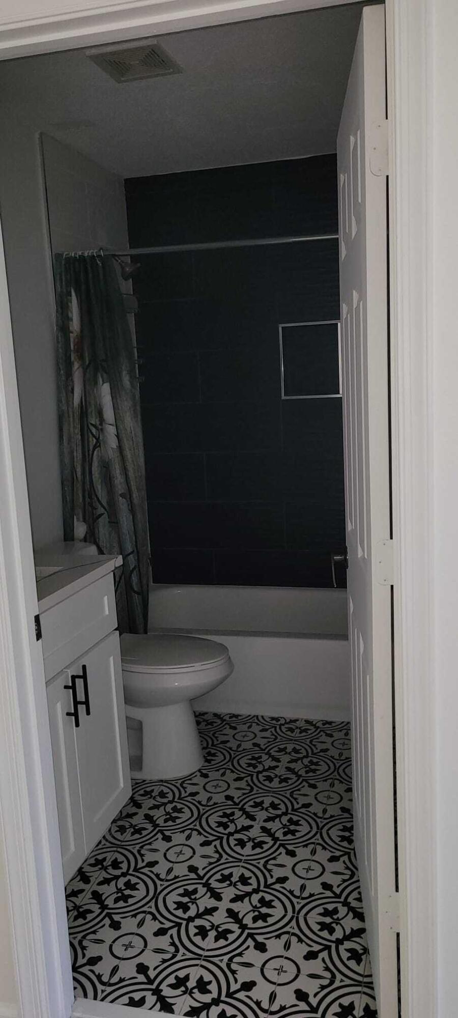 3478 Briar Bay Boulevard, Unit 202 West Palm Beach, FL 33411 - Photo 22 of 23 a bathroom with a toilet and a shower