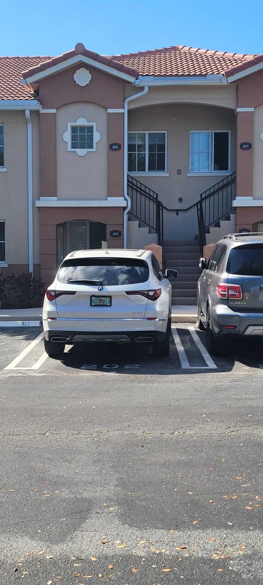 3478 Briar Bay Boulevard, Unit 202 West Palm Beach, FL 33411 - Photo 23 of 23 a view of a car park in front of house