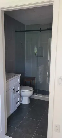 a white toilet sitting next to a bathroom sink