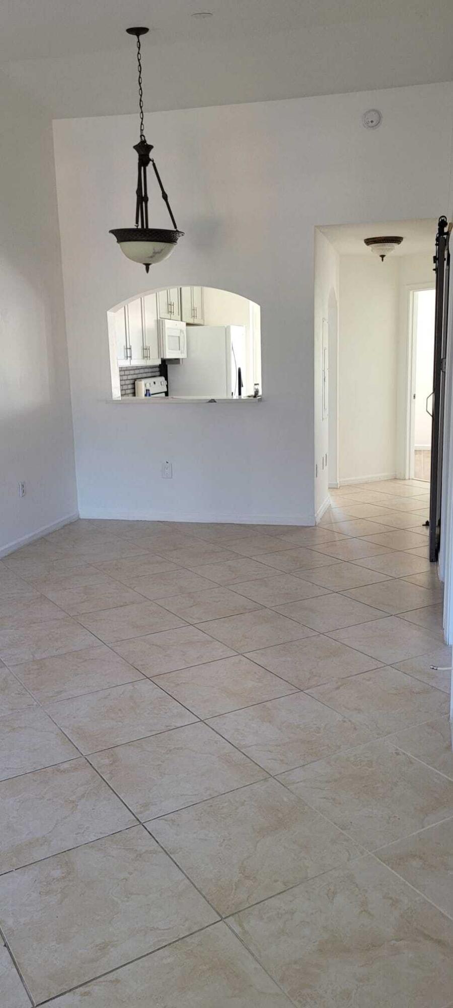 3478 Briar Bay Boulevard, Unit 202 West Palm Beach, FL 33411 - Photo 9 of 23 a view of empty room with wooden floor
