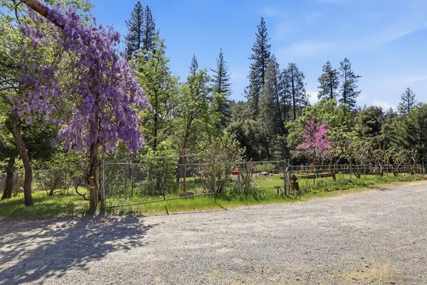a view of a house with a yard and sitting area
