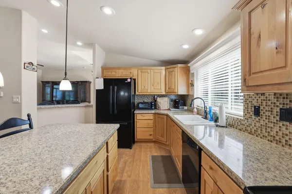 a living room with furniture and kitchen view
