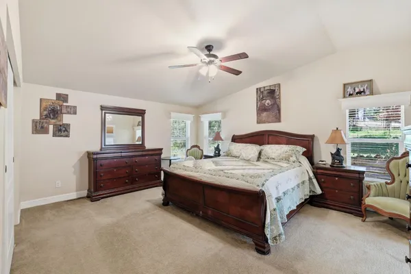 a front view of a house with yard and green space