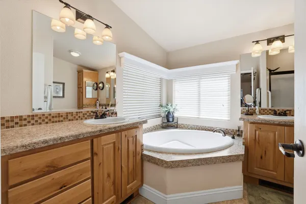 a view of a house with backyard and a tree