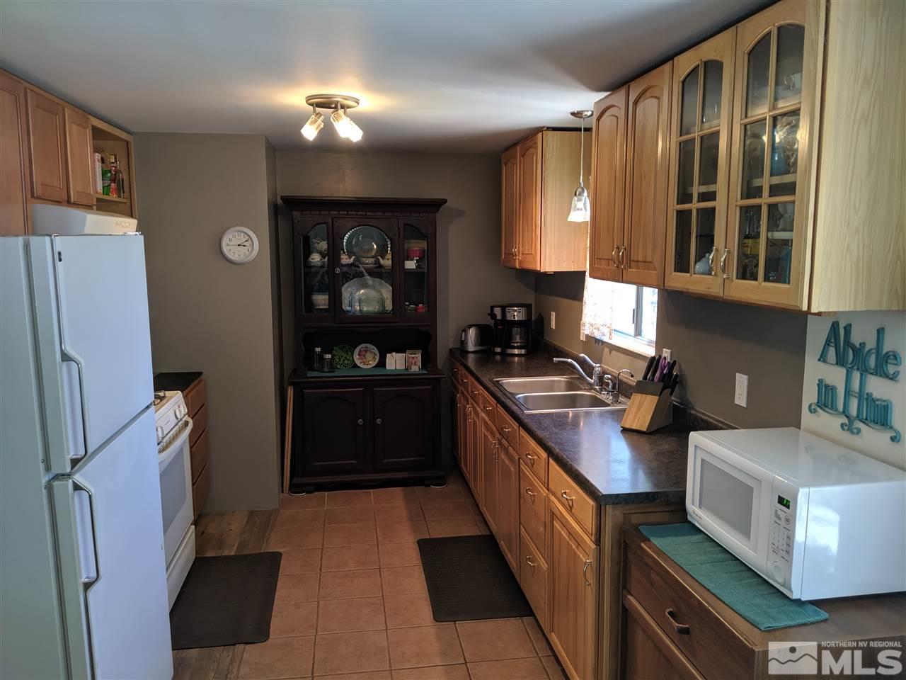 9290 Fremont Way Reno, NV 89506 - Photo 3 of 18 a kitchen with stainless steel appliances granite countertop a stove a refrigerator and a stove
