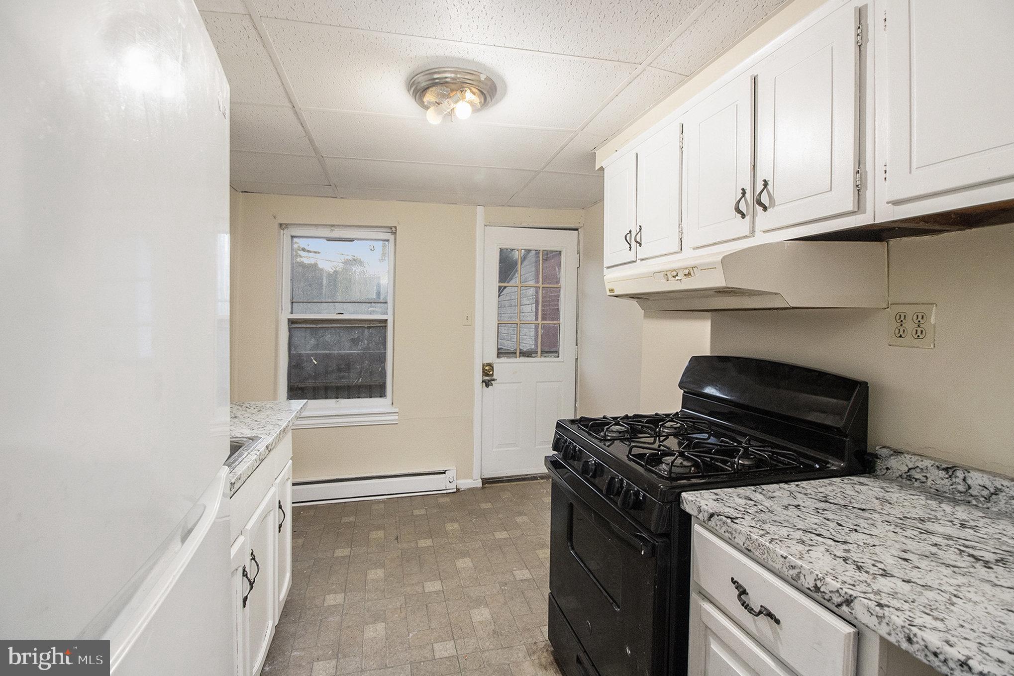809 George Street Norristown, PA 19401 - Photo 8 of 24 a kitchen with a stove and a refrigerator