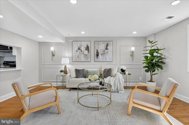 a living room with furniture a couch and a potted plant