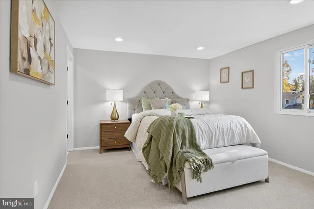 a bedroom with a bed and painting on the wall