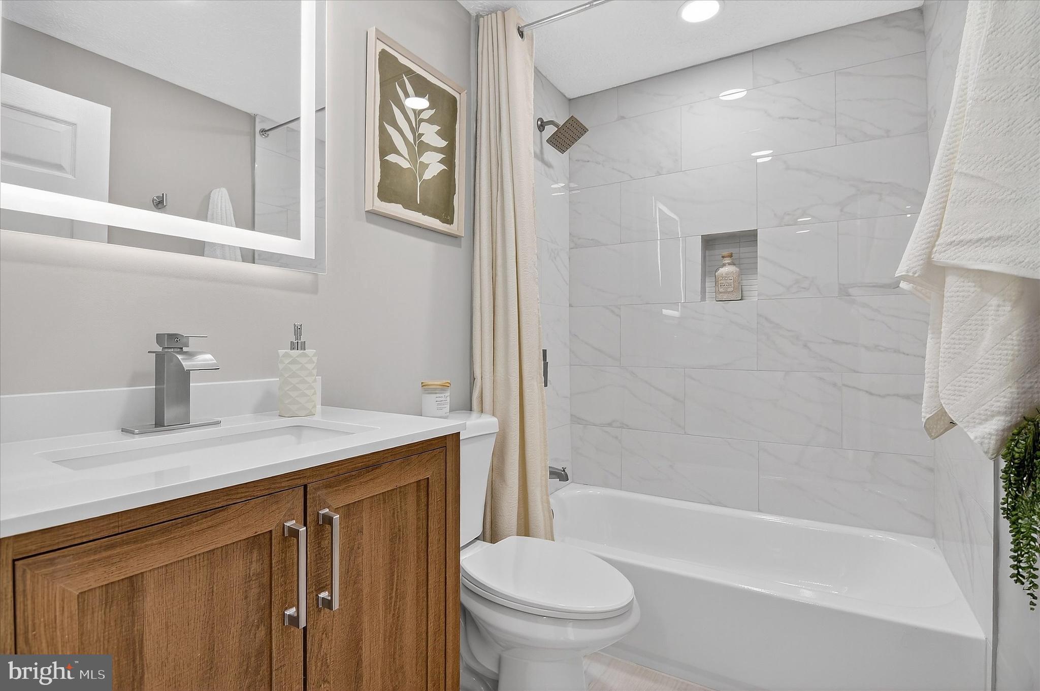 3681 Masthead Trail Triangle, VA 22172 - Photo 30 of 40 a bathroom with a granite countertop sink toilet and shower