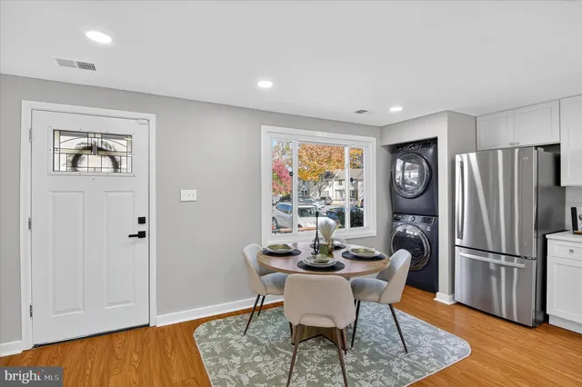 a dining room with furniture and wooden floor