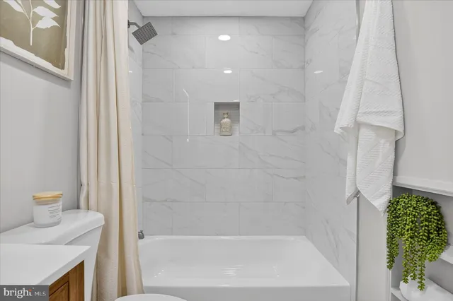 a bathroom with a tub and shower