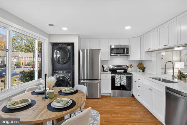a kitchen with sink refrigerator stove and microwave