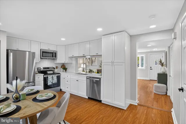 a kitchen with stainless steel appliances granite countertop a refrigerator stove and sink