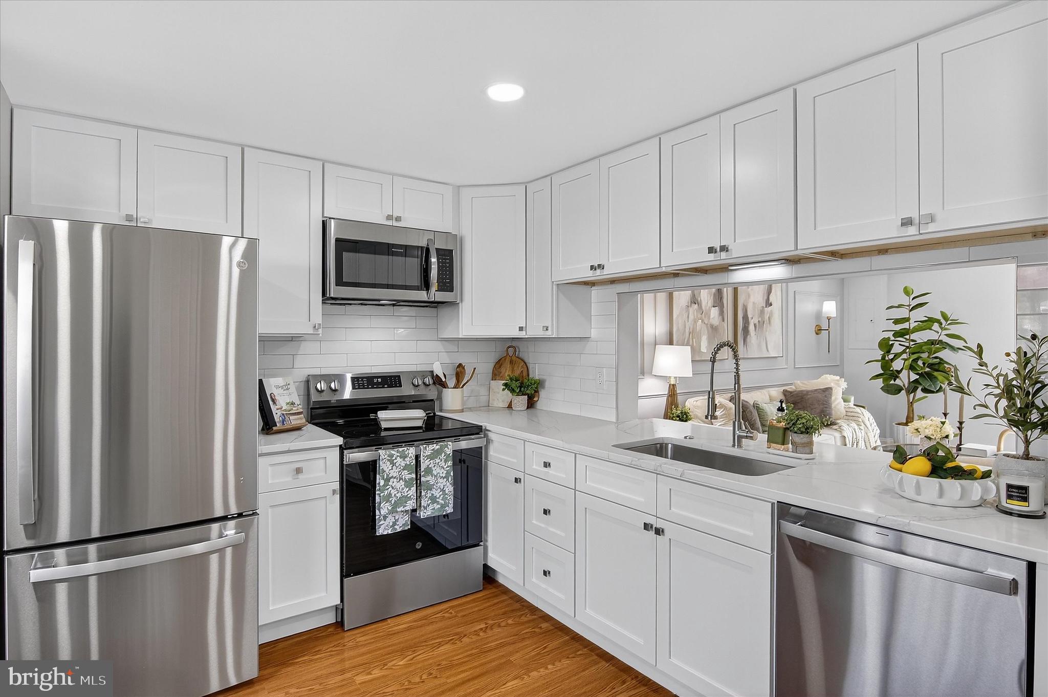 3681 Masthead Trail Triangle, VA 22172 - Photo 8 of 40 a kitchen with cabinets stainless steel appliances and wooden floor