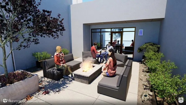 a living room with furniture and a potted plant