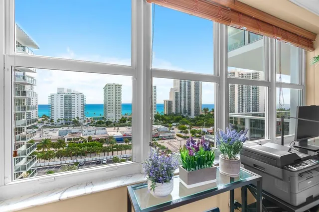 a living room filled with furniture and a potted plant