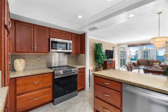 a kitchen with granite countertop stainless steel appliances and wooden cabinets