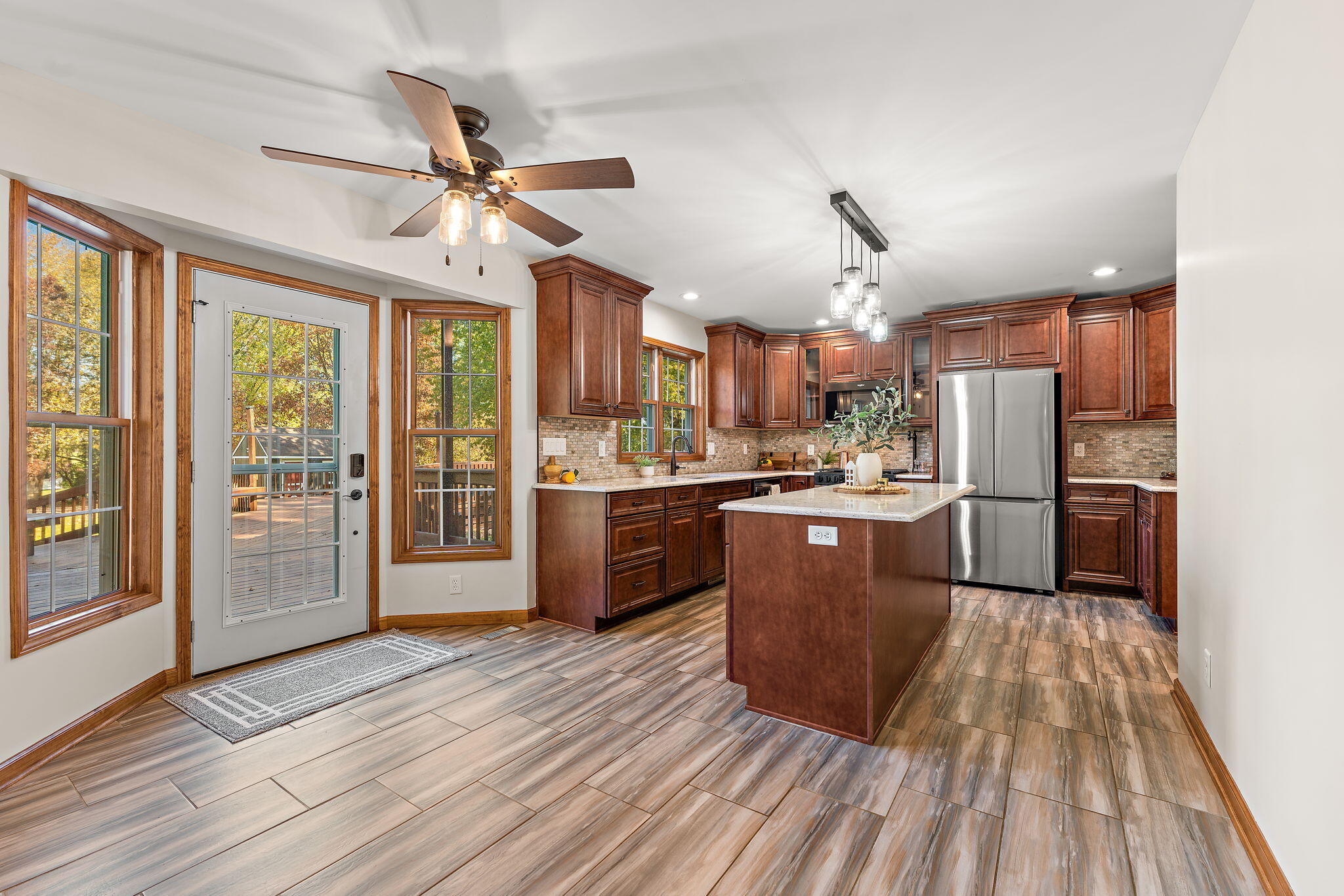 375 Reif Drive Hebron, IN 46341 - Photo 16 of 58 a kitchen view with granite countertop wooden floors stainless steel appliances and window