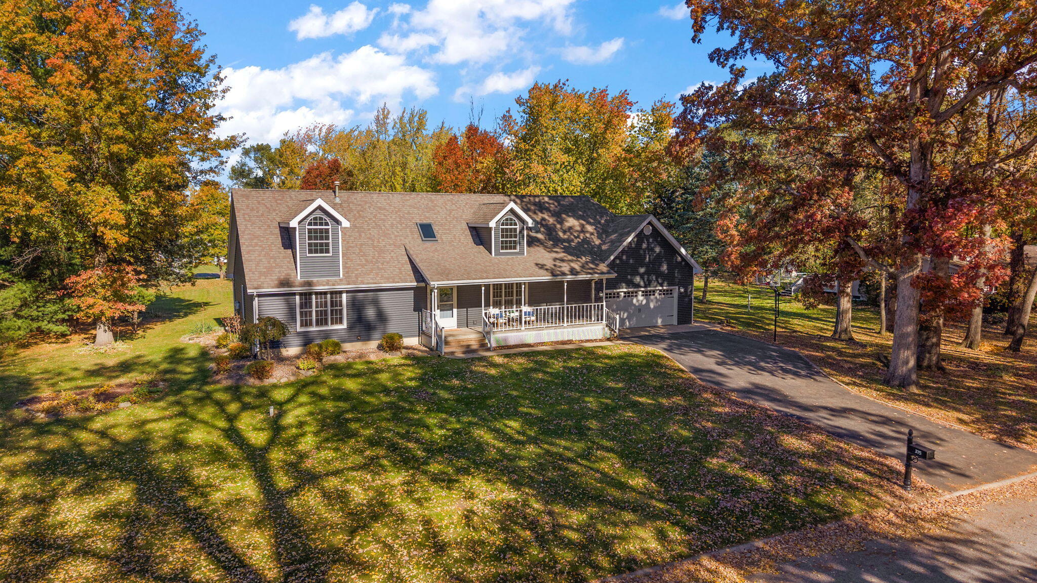 375 Reif Drive Hebron, IN 46341 - Photo 2 of 58 a view of a house with a big yard and large trees