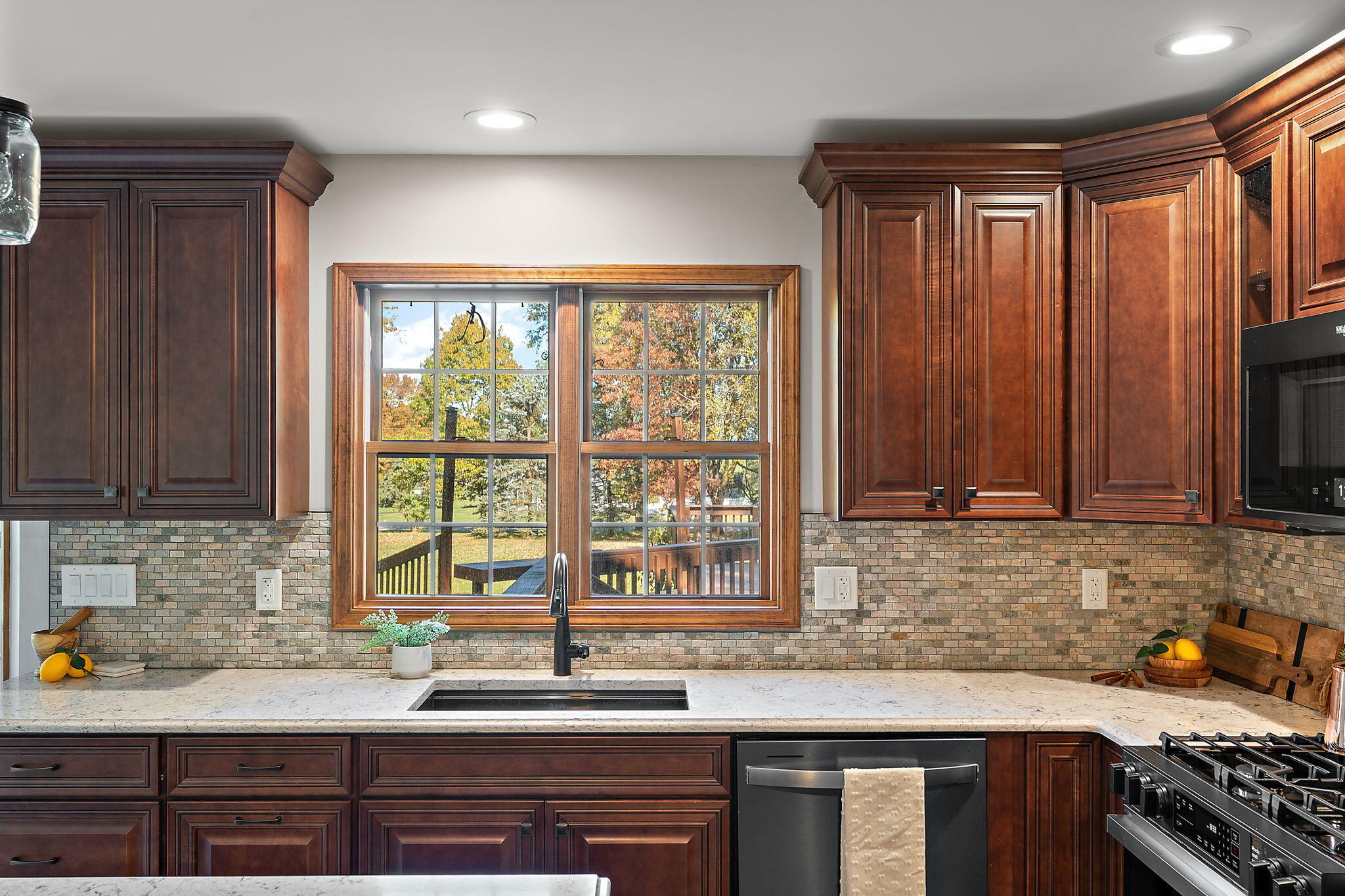 375 Reif Drive Hebron, IN 46341 - Photo 22 of 58 a kitchen with stainless steel appliances granite countertop a sink a stove and a microwave