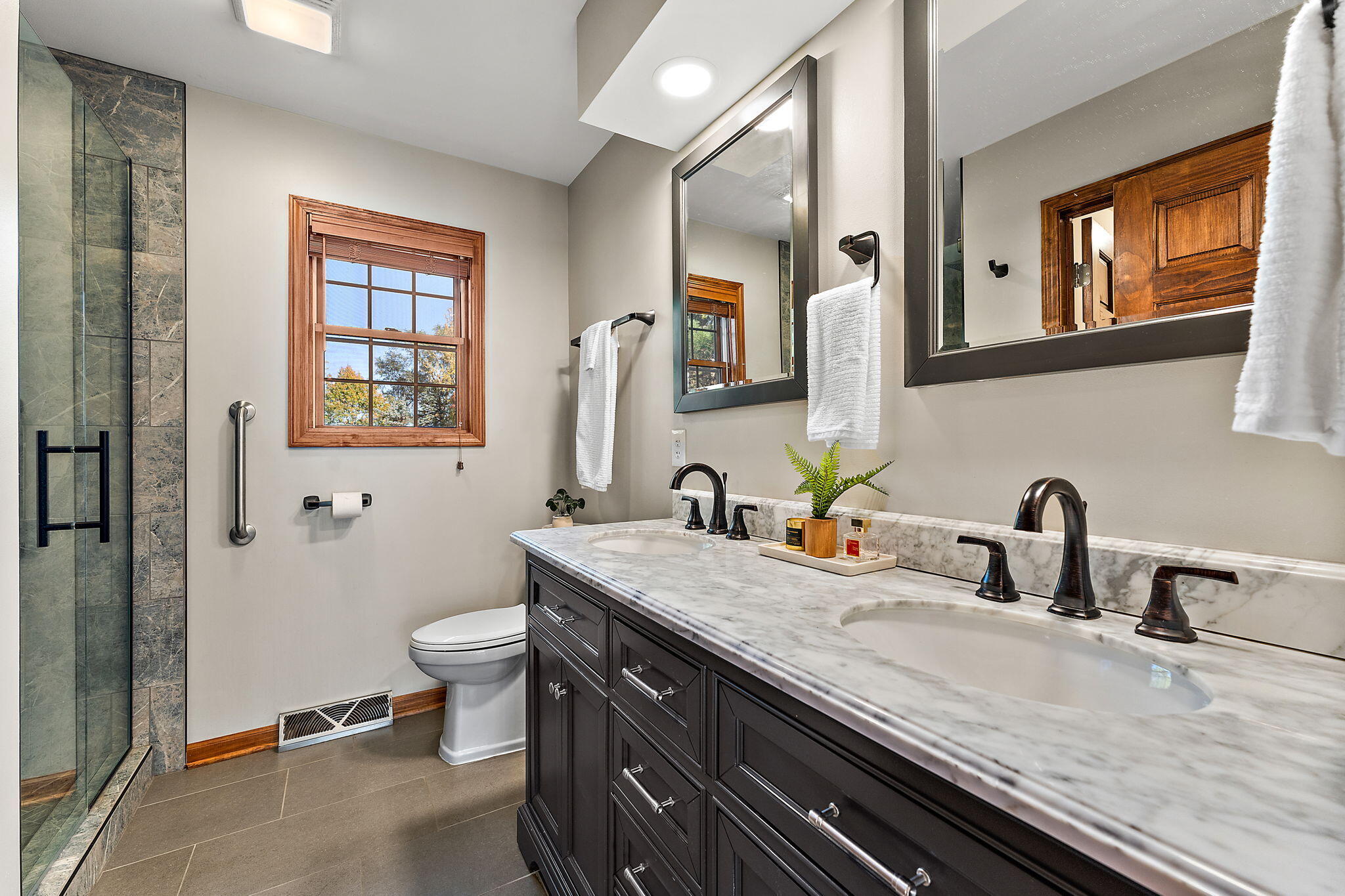 375 Reif Drive Hebron, IN 46341 - Photo 28 of 58 a bathroom with a granite countertop sink a toilet and with mirror