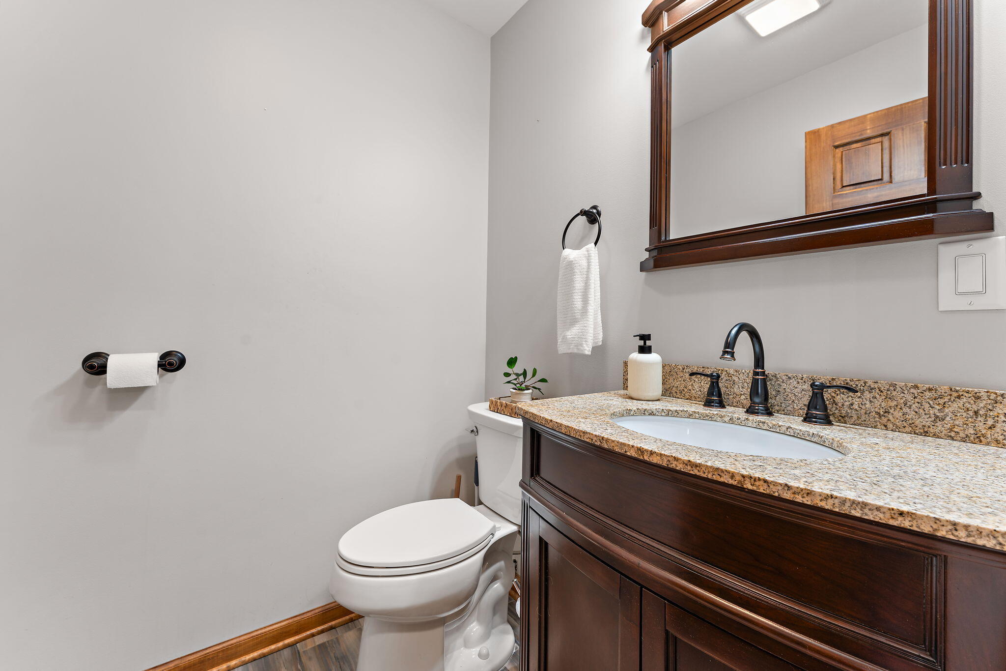 375 Reif Drive Hebron, IN 46341 - Photo 32 of 58 a bathroom with a granite countertop sink a toilet and mirror