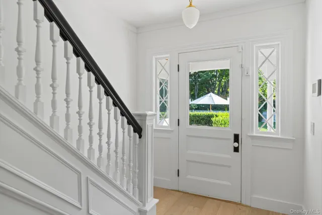 a view of an entryway with wooden floor