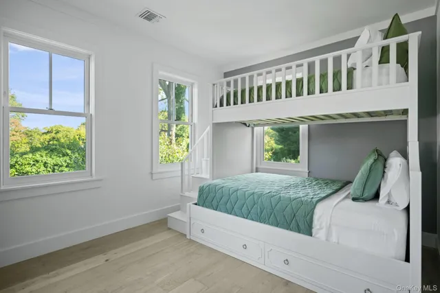 a bedroom with bed and a window