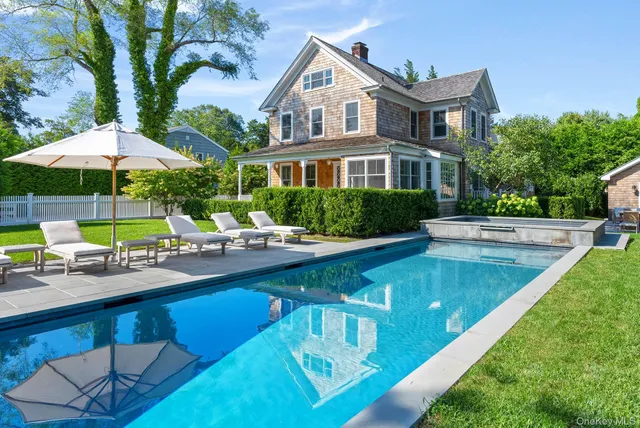 a view of a house with swimming pool and sitting area