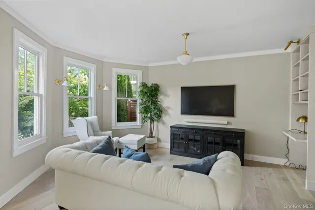 a living room with furniture a fireplace and a flat screen tv