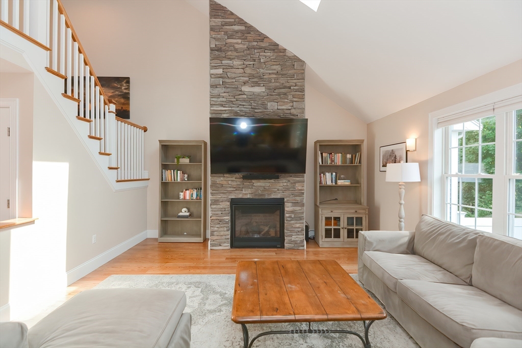 29 Webb Place, Unit A Mansfield, MA 02048 - Photo 17 of 42 a living room with furniture a flat screen tv and a fireplace