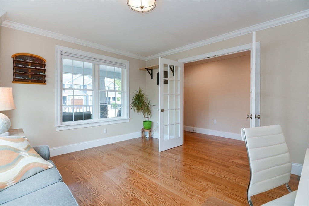 29 Webb Place, Unit A Mansfield, MA 02048 - Photo 21 of 42 a view of an empty room with wooden floor and a window
