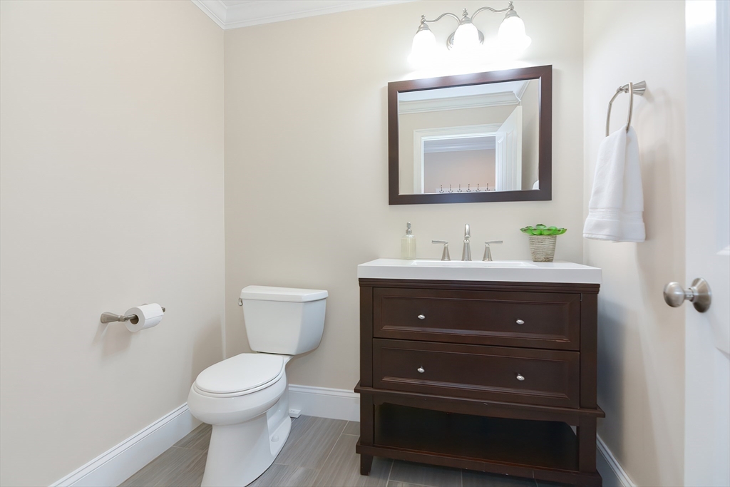 29 Webb Place, Unit A Mansfield, MA 02048 - Photo 24 of 42 a bathroom with a toilet sink and mirror