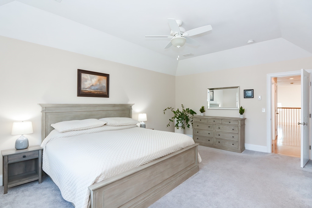 29 Webb Place, Unit A Mansfield, MA 02048 - Photo 25 of 42 a bedroom with a bed and a chandelier