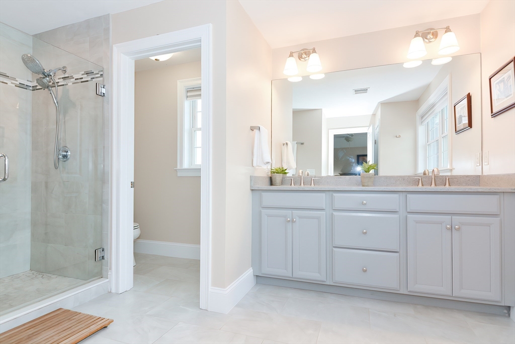 29 Webb Place, Unit A Mansfield, MA 02048 - Photo 28 of 42 a spacious bathroom with a shower a sink and mirror