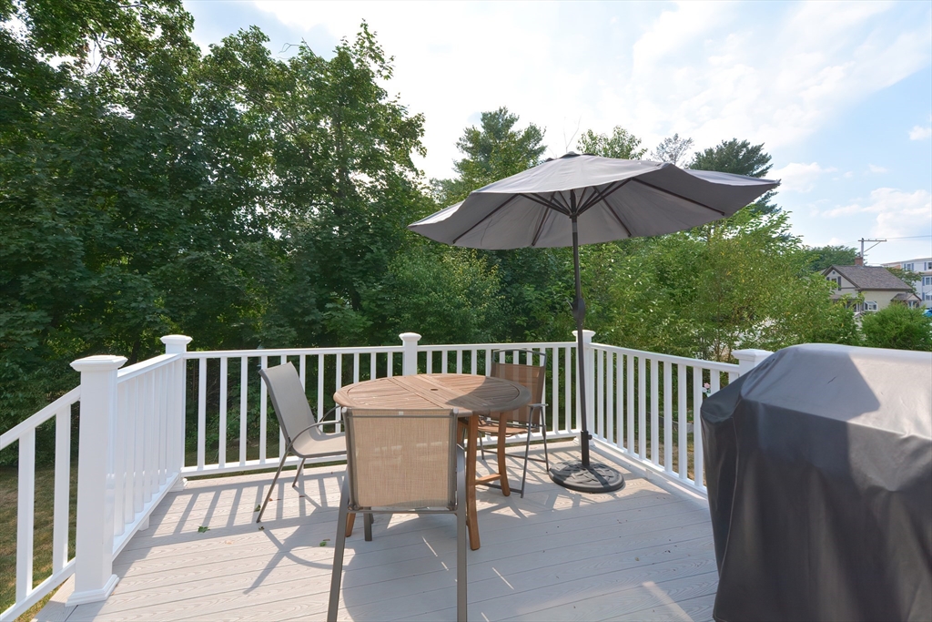 29 Webb Place, Unit A Mansfield, MA 02048 - Photo 37 of 42 a view of balcony with furniture and umbrella