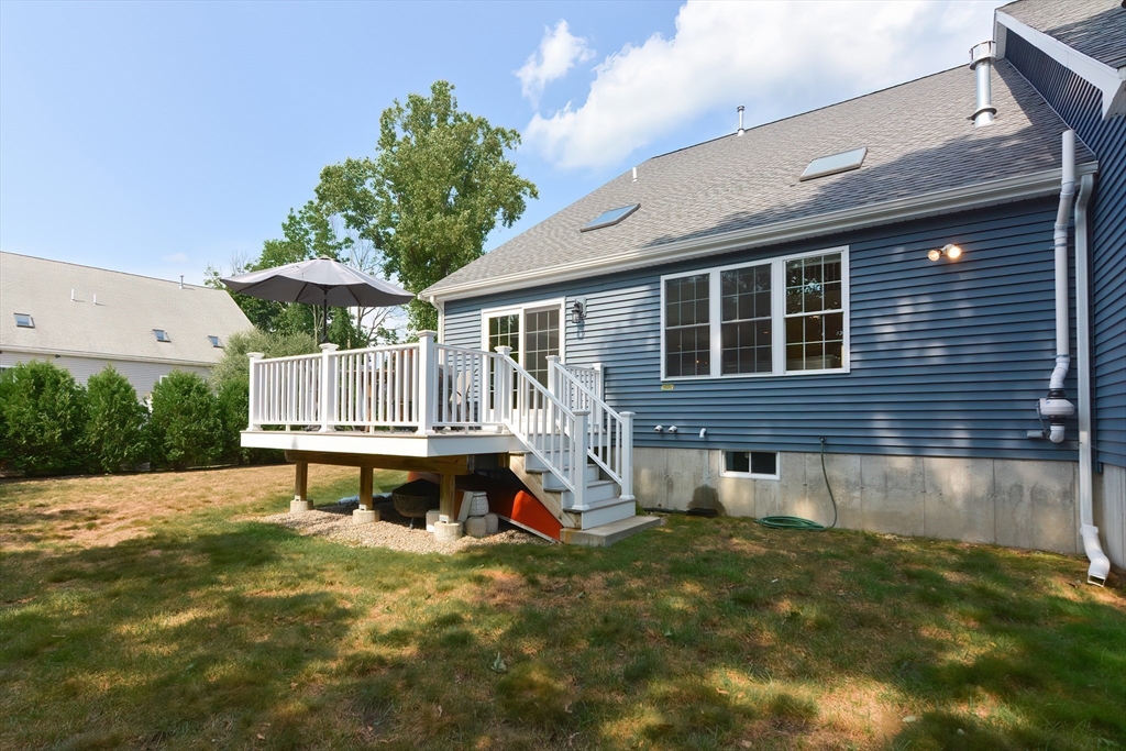 29 Webb Place, Unit A Mansfield, MA 02048 - Photo 38 of 42 a view of a house with a yard and sitting area