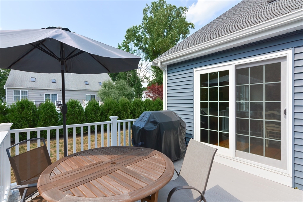 29 Webb Place, Unit A Mansfield, MA 02048 - Photo 39 of 42 a view of a chair and table on the deck