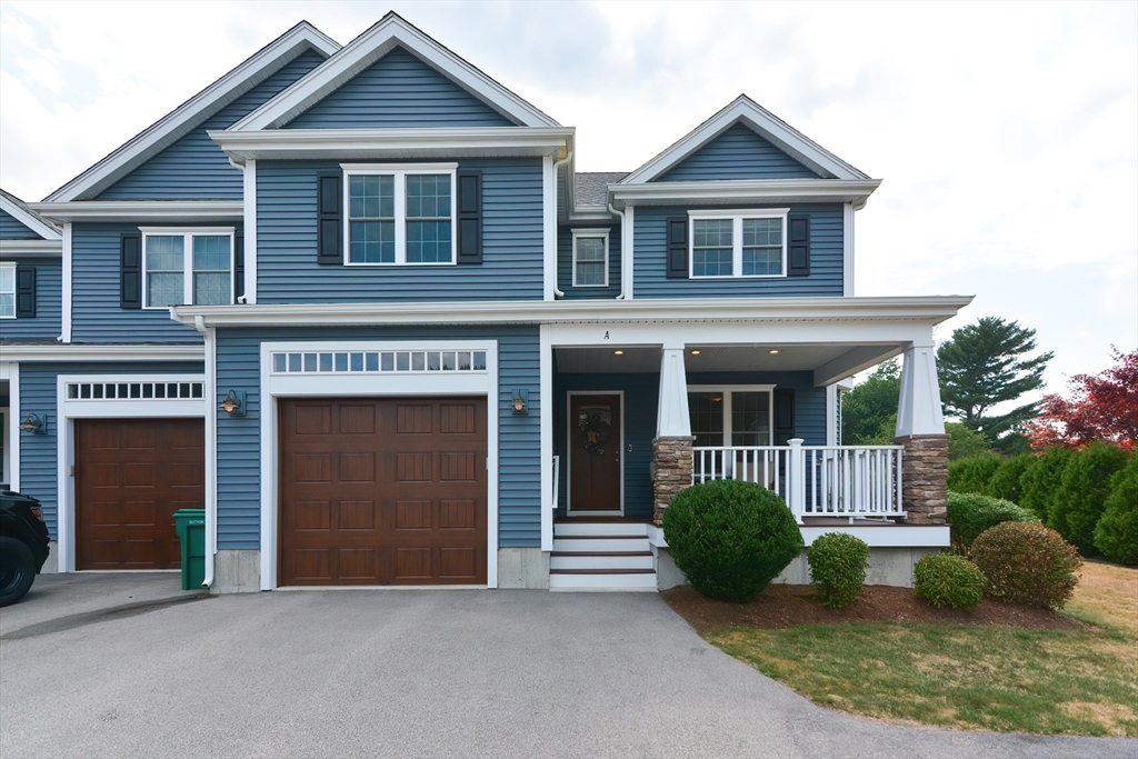 29 Webb Place, Unit A Mansfield, MA 02048 - Photo 41 of 42 a front view of a house with garden