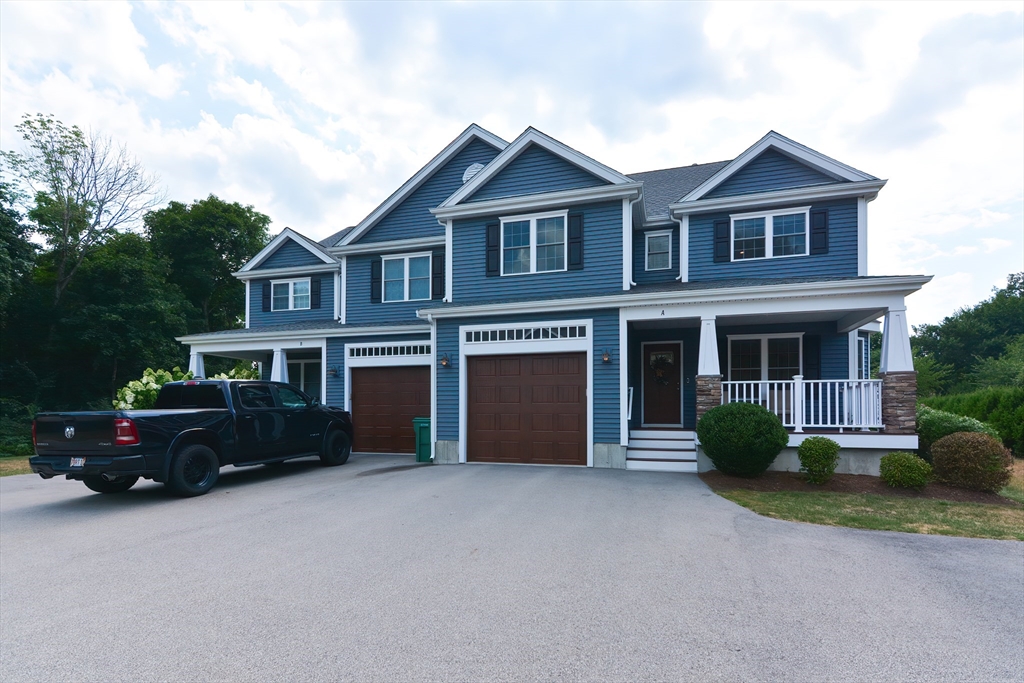 29 Webb Place, Unit A Mansfield, MA 02048 - Photo 42 of 42 a front view of a house with a garden
