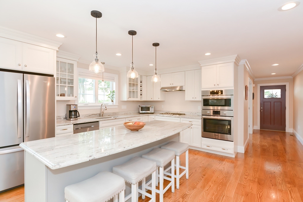 29 Webb Place, Unit A Mansfield, MA 02048 - Photo 5 of 42 a kitchen with a sink a refrigerator and wooden floor