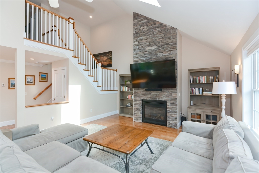 29 Webb Place, Unit A Mansfield, MA 02048 - Photo 7 of 42 a living room with furniture a flat screen tv and a fireplace