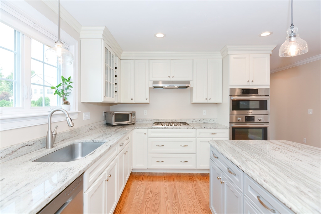 29 Webb Place, Unit A Mansfield, MA 02048 - Photo 10 of 42 a kitchen with stainless steel appliances granite countertop a sink stove and refrigerator